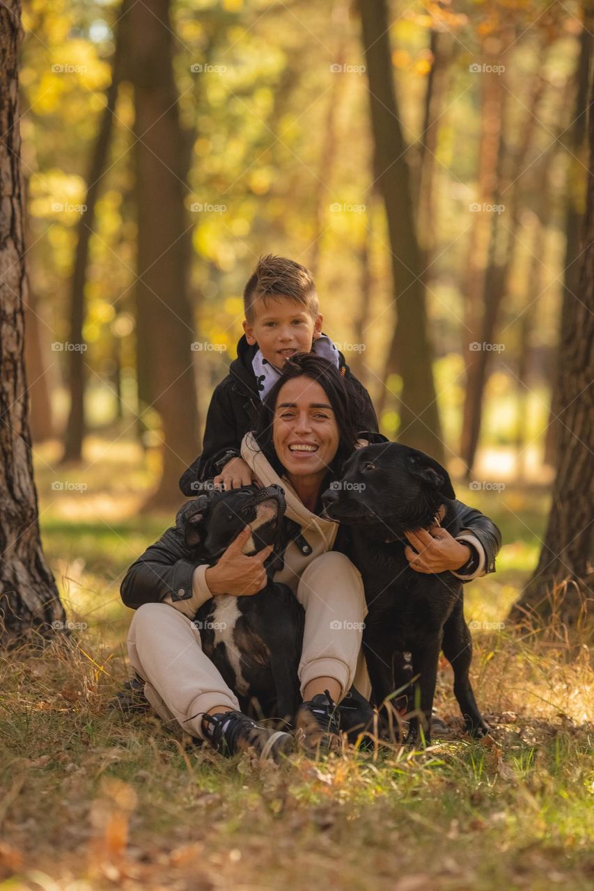 walking the dog down the street, the owner walks the weakling, teaches her, cleans up after her, educates, plays with his pet. people and dogs are best friends