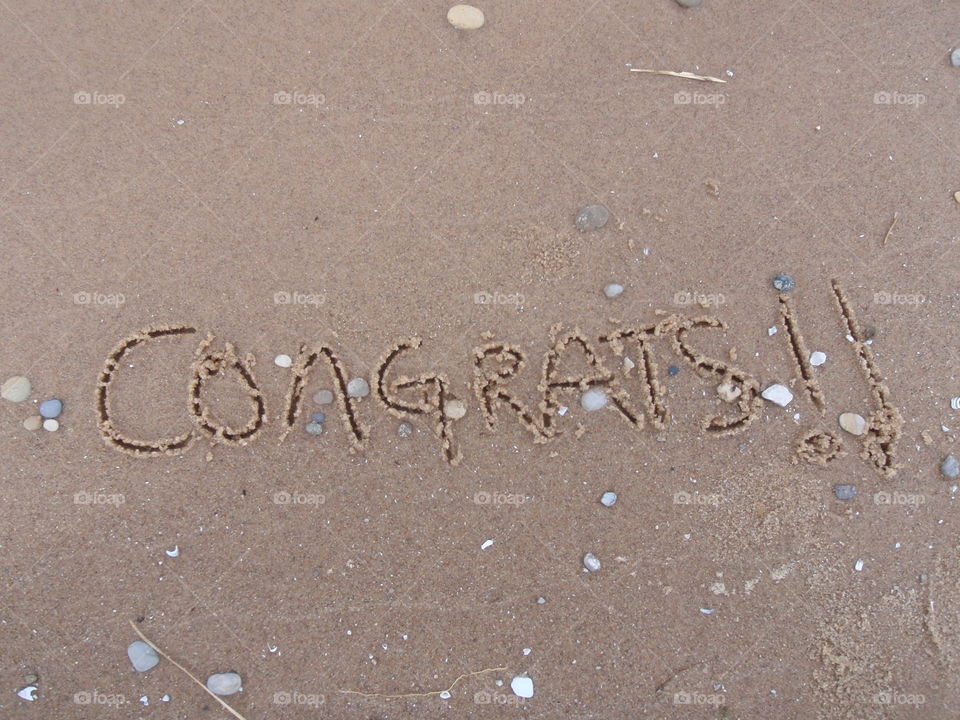 Congrats!. Congrats! Message written in the sand