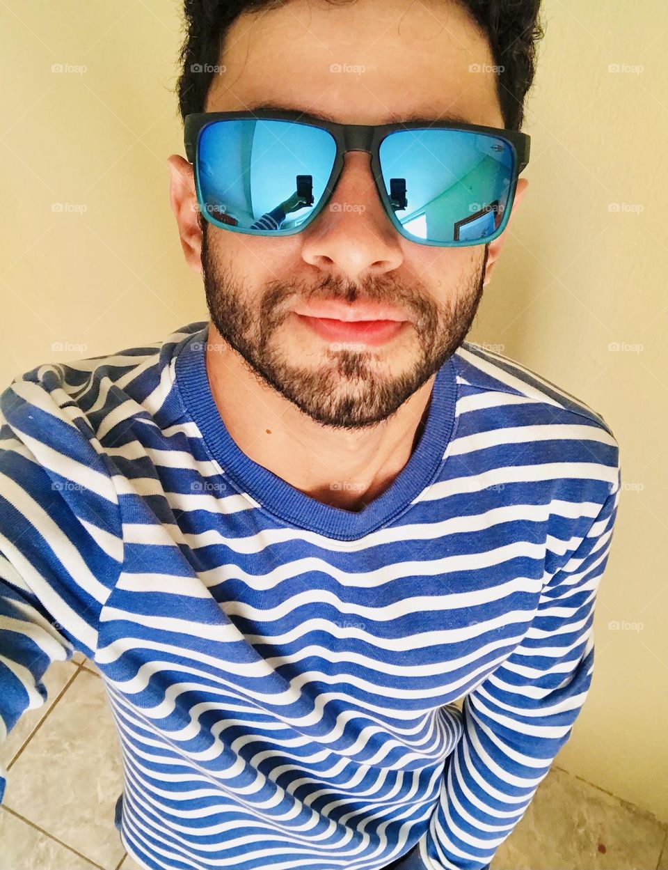 Handsome man with beard and glasses taking selfie