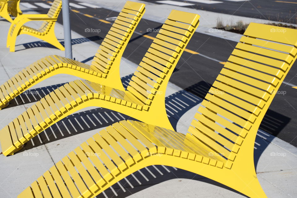 Yellow lounge chairs on sidewalk 