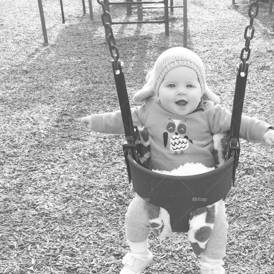 Swinging. Baby seining at park. 
