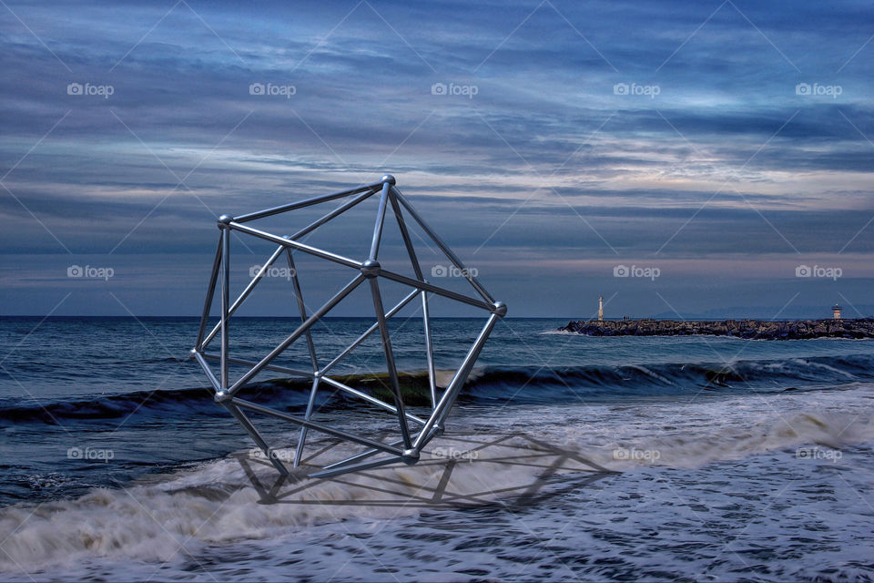 Icosahedrons metallic figure at sea