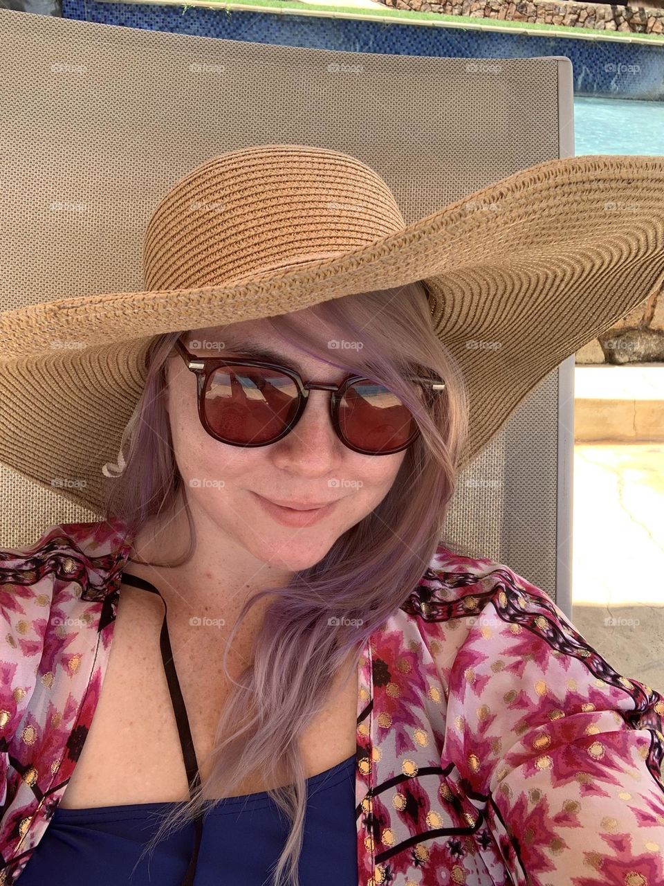 Pool vibes. Long blonde and purple hair. Big hat and swimwear 