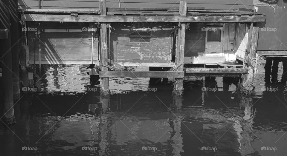 pylons marked 11, 12, 13 and 14..possibly for boat docking but this is no longer used. A back door from building to the water has long been boarded up. photo taken on the old wharf of Monterey, CA