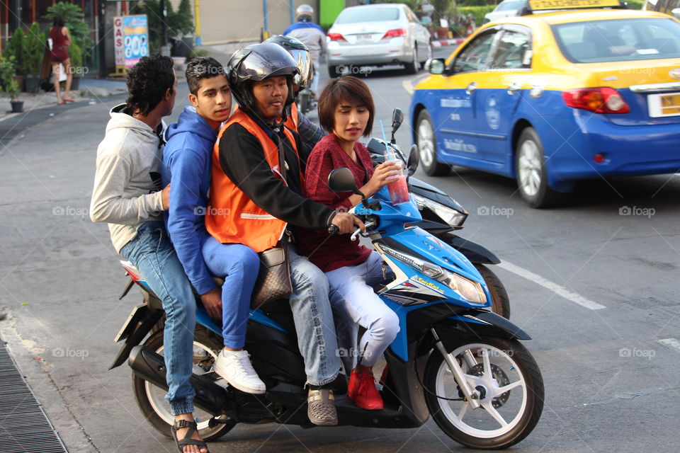 Four on a motorcycle taxi