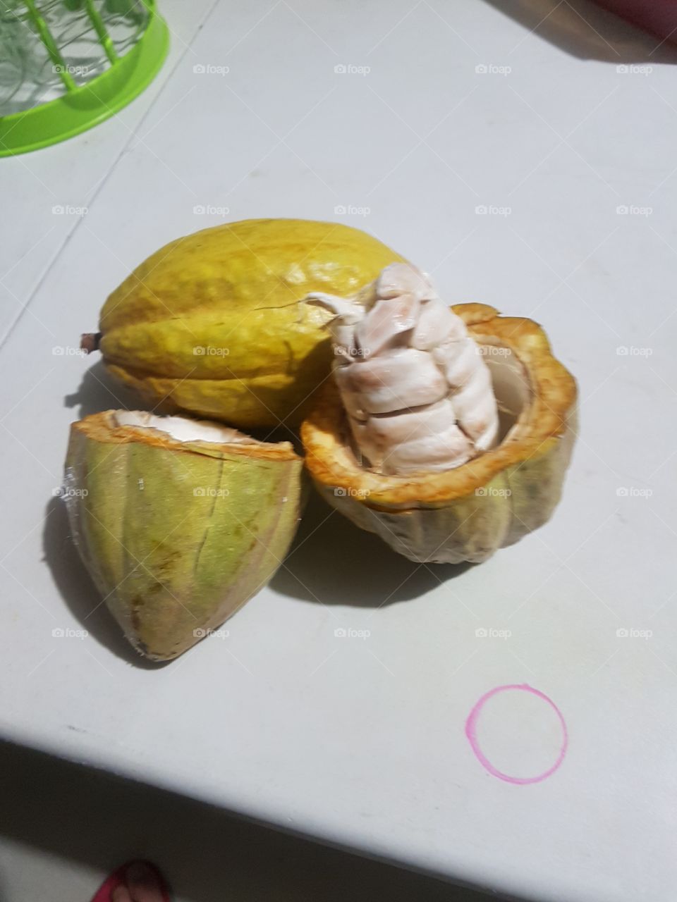 This is a cacao fruit. Its the main source of chocolate. The taste is yummy. I was thinking before that the pulp is like that of a big almond seed, small seeds similar to santol seeds.