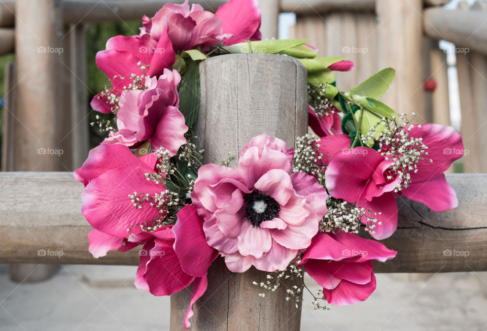 Pink flower crown on the wooden fence