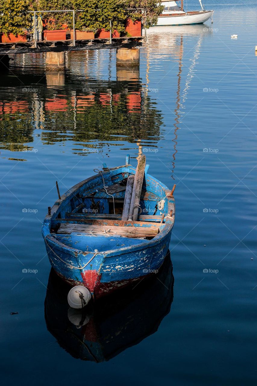 Fishing boat and blue water reflection