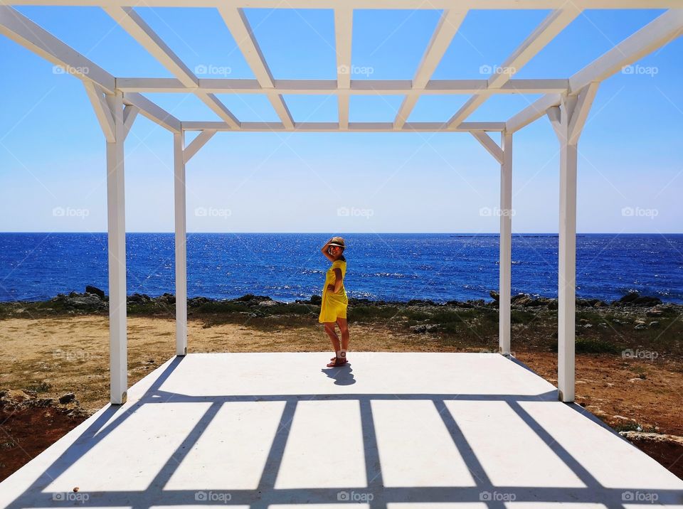 linear shadows on a terrace overlooking the sea