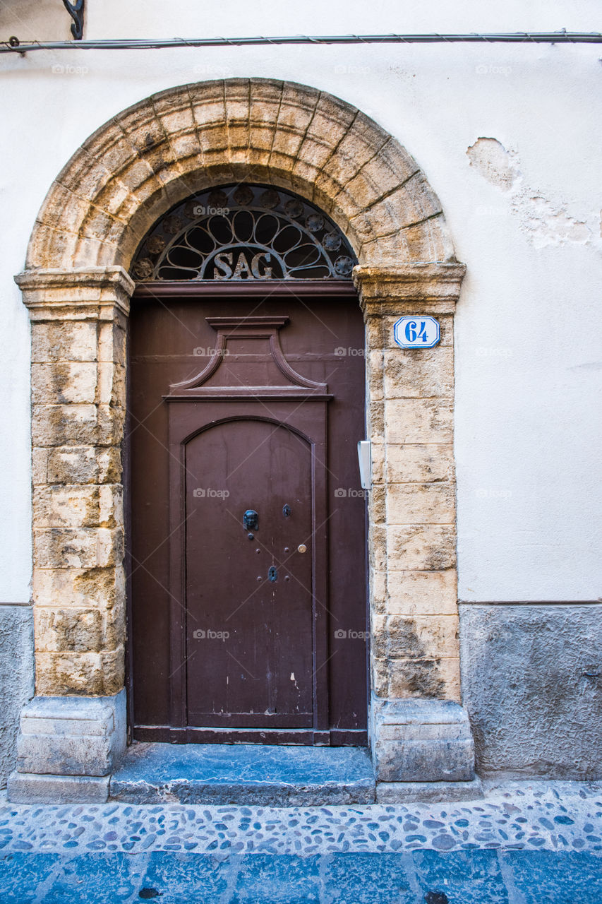 Old door in the city of Cefalu on Sicily.