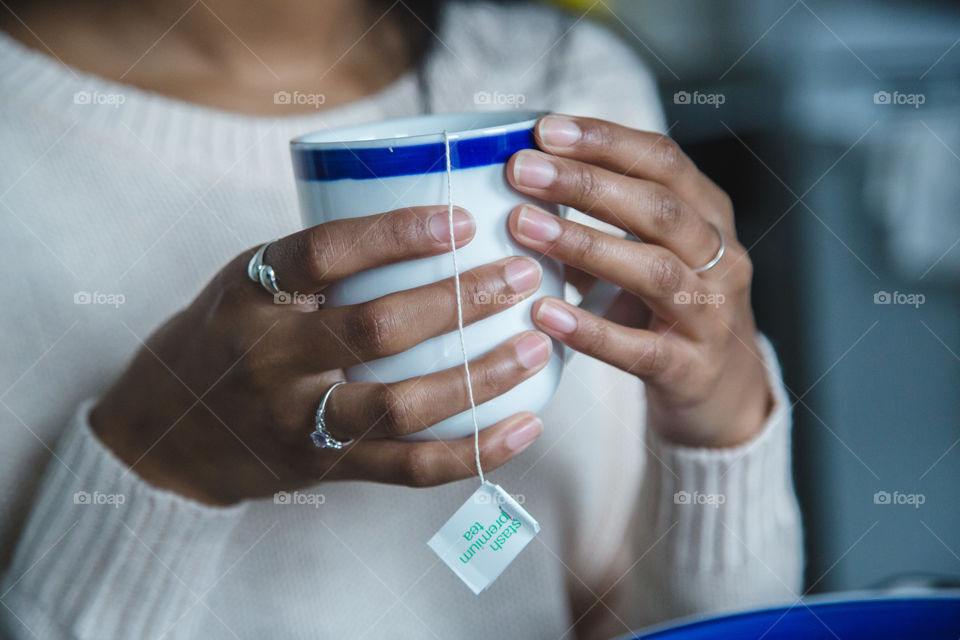 Hands holding a cup of tea