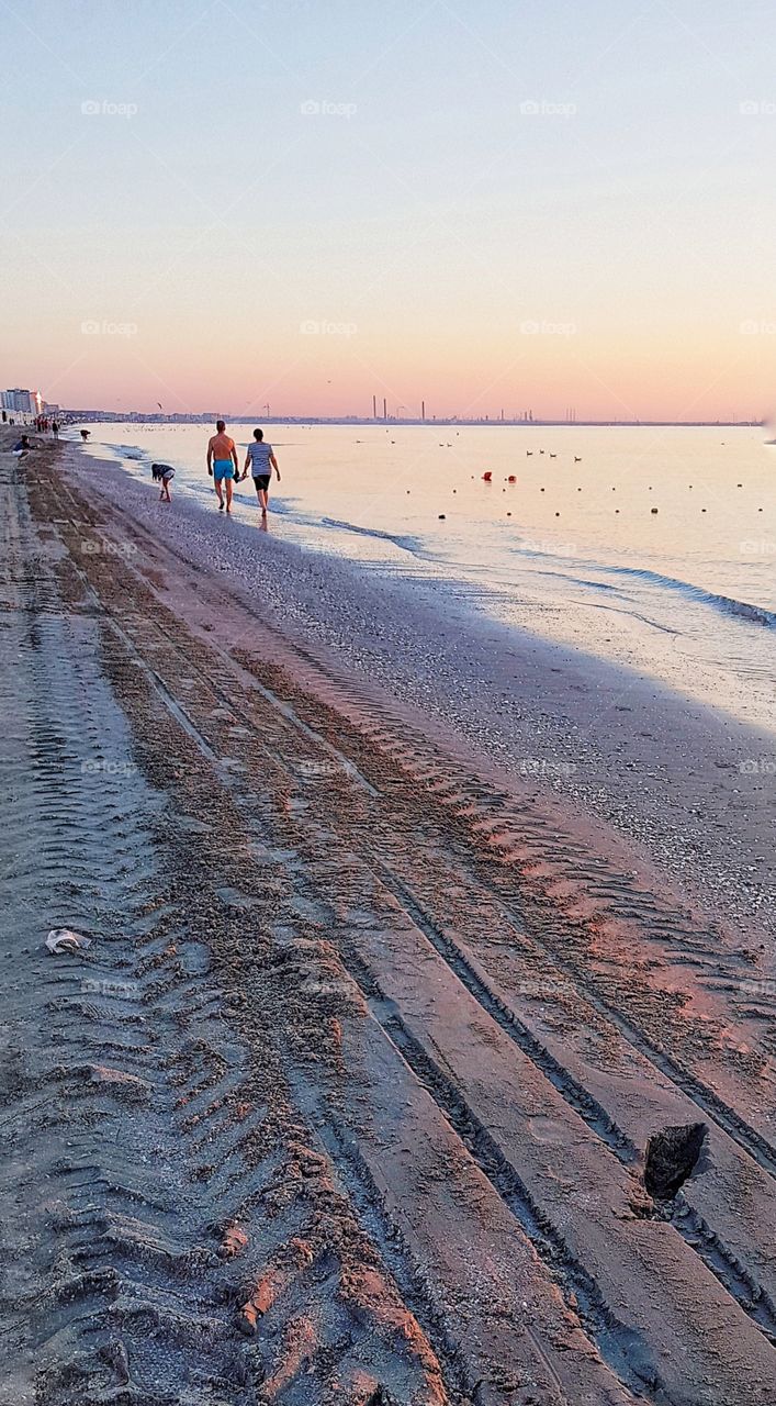 Walking hand in hand on the beach.