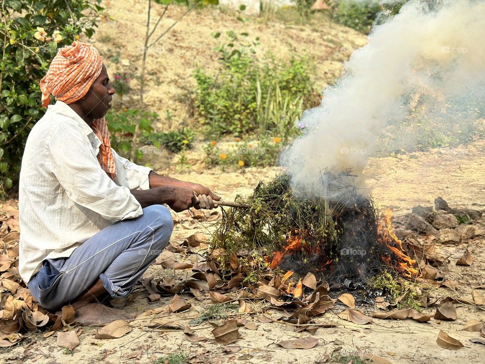 Indian man roasting nuts 