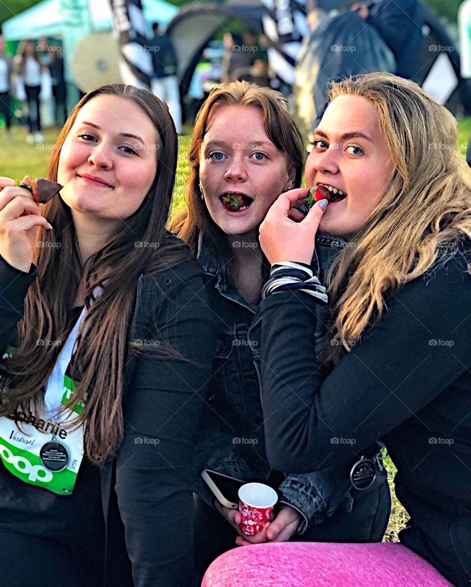 Women tasting strawberry 