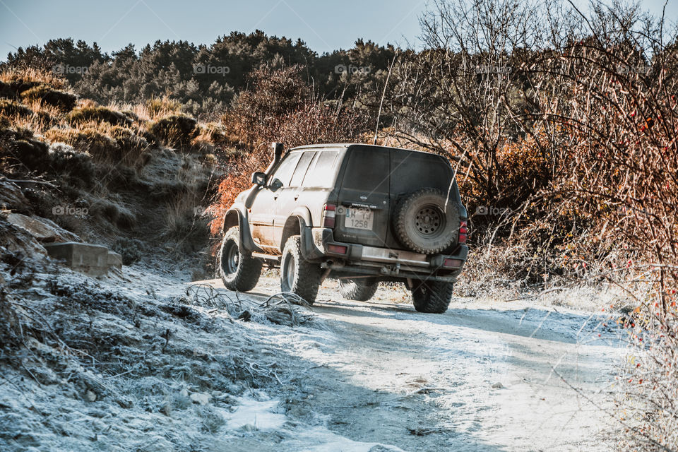 Allroad car going fast through the snow trail