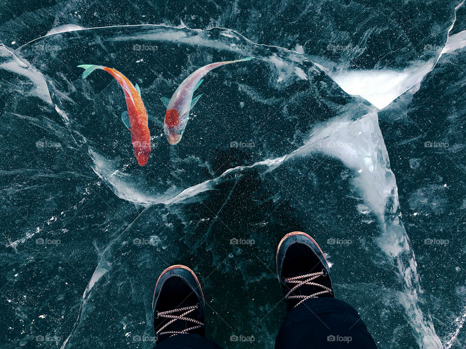 Standing on blue frozen lake in winter 