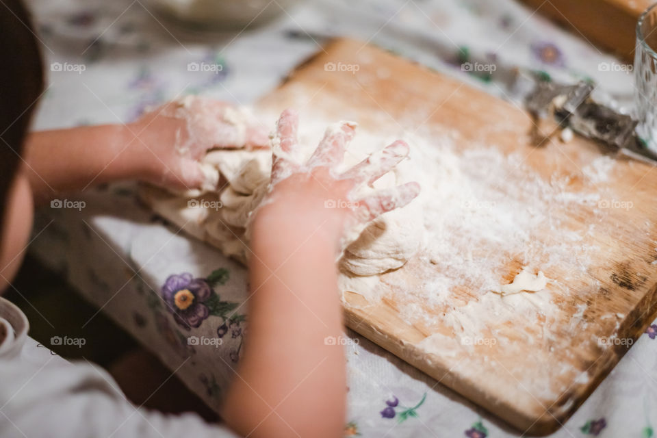 Child while playing with pasta and flour during the quarantine from Covid-19