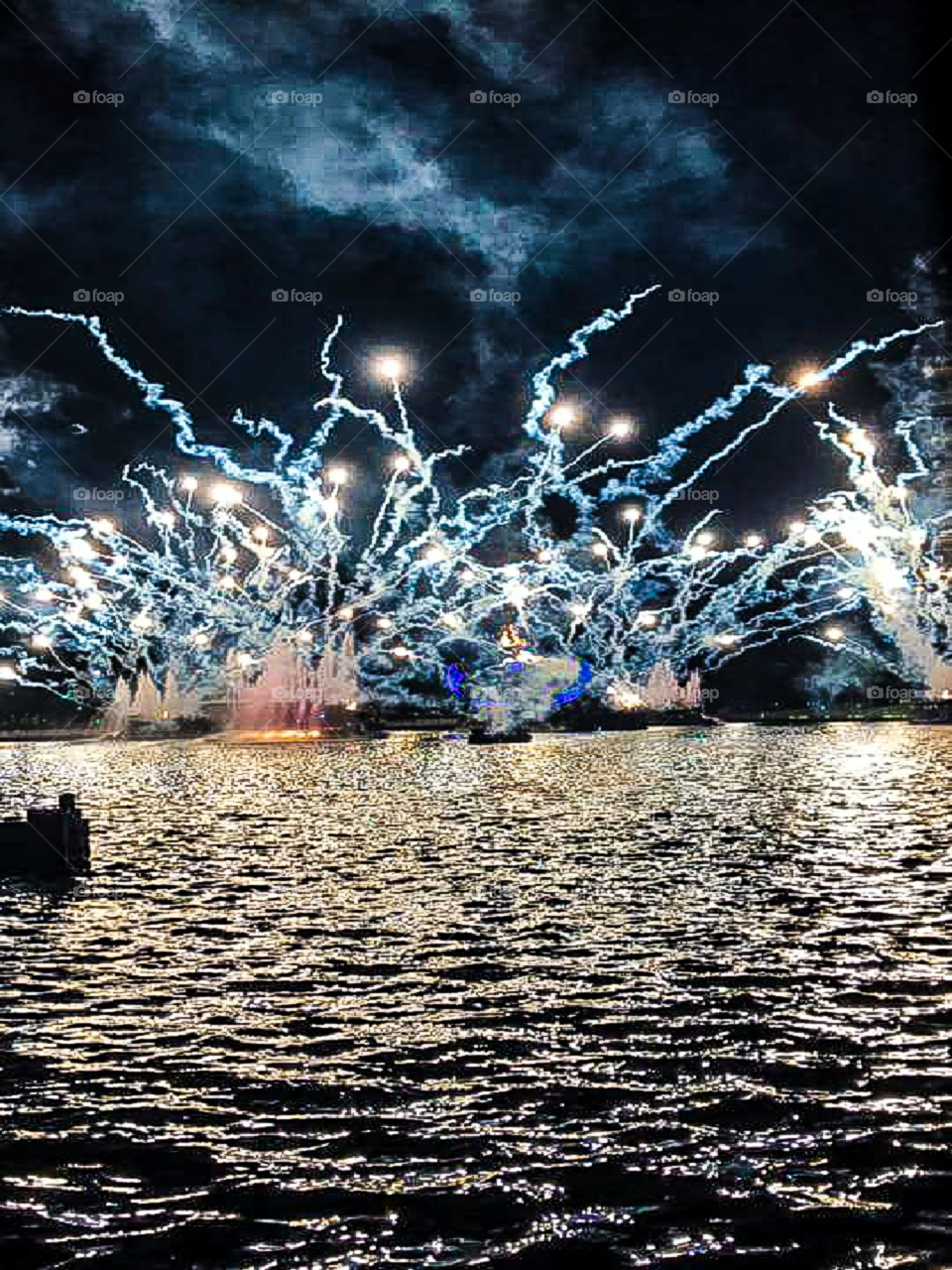 fireworks display over water at night