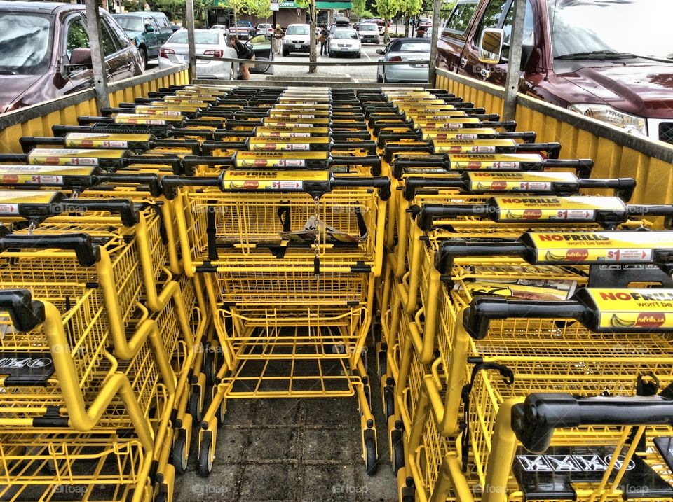 bright yellow shopping carts. Yellow shopping grocery carts in parking lot