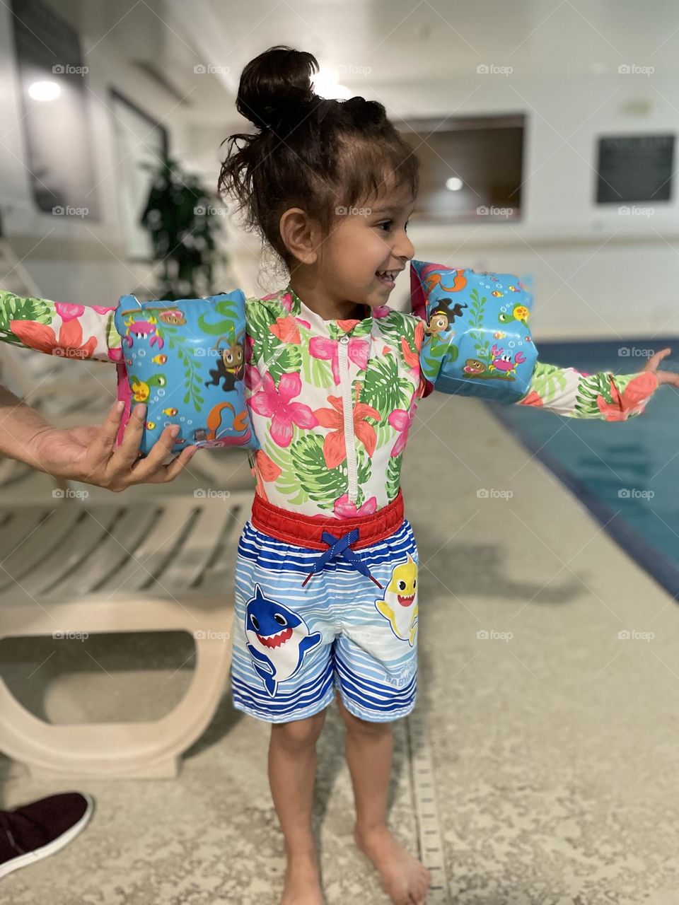 Getting ready for the pool, putting swim floaties on a toddler, flotation devices save lives, being safe in the water, water safety with toddlers 