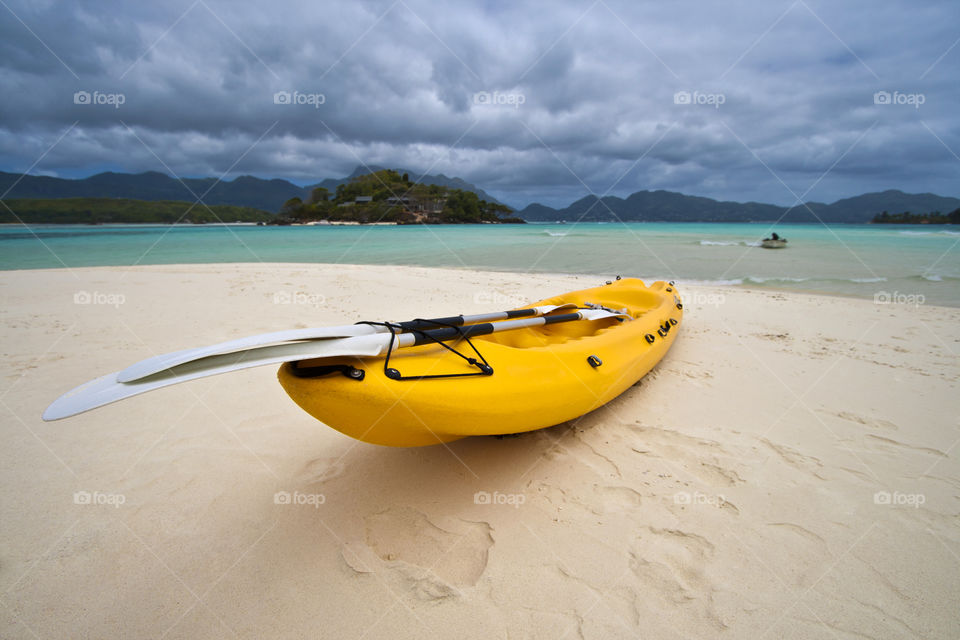 Yellow boat on a tropical island. Summer holiday fun.