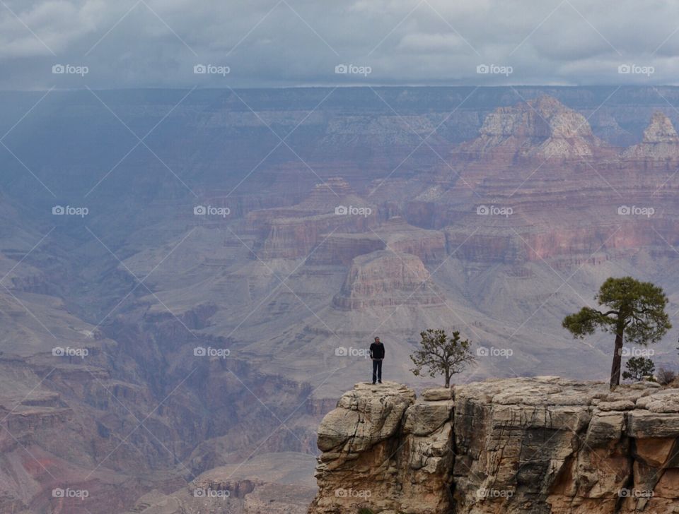 Young man standing on the edge of the Grand Canyon