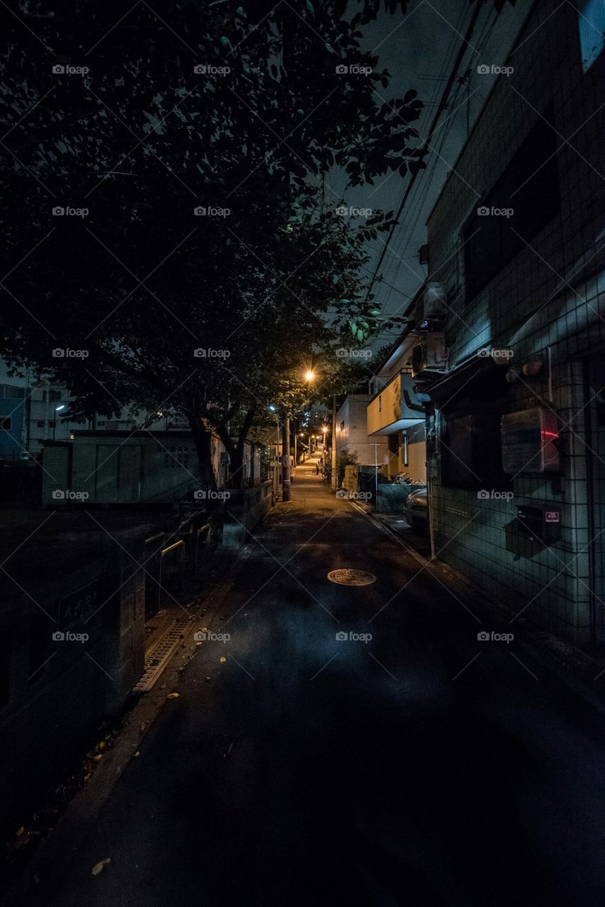 A view of a back street at night.