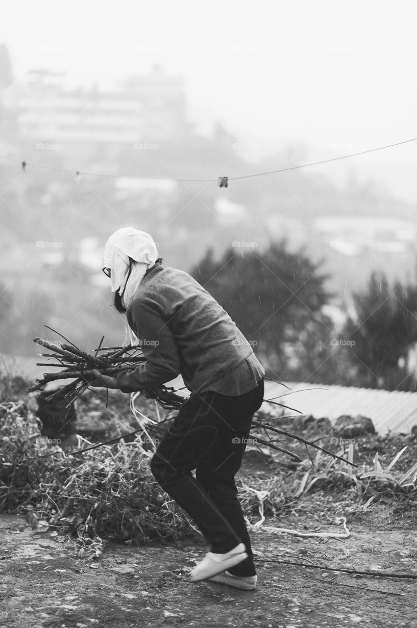 Capturing motion in black and white, a woman running for shelter in the rain.