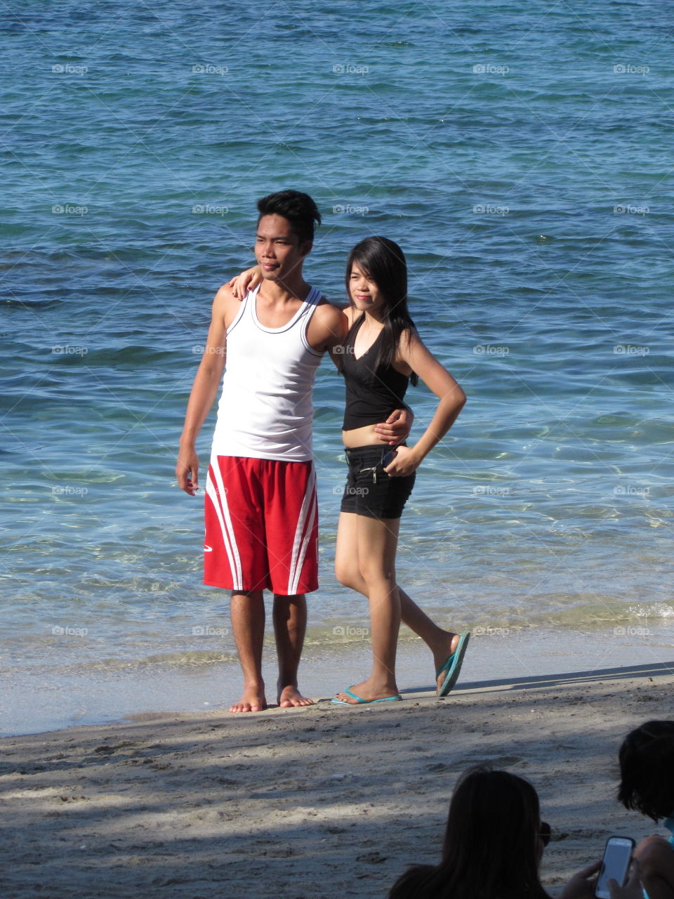 Posing couple at White Beach, Puerto Galera in Philippines 