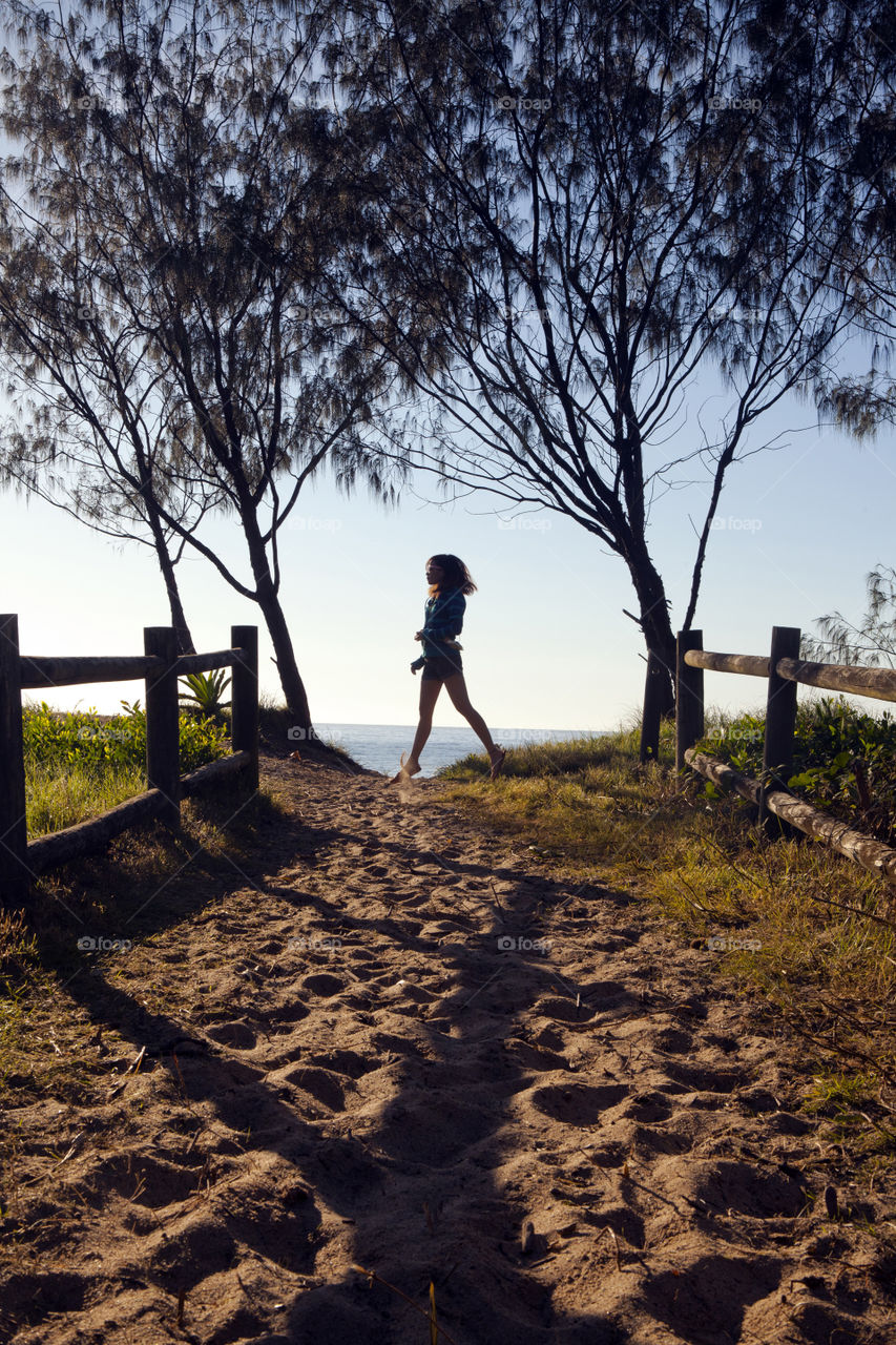 Exploring Australia, Girl in pathway to the beach entrance of  Coffs Harbour