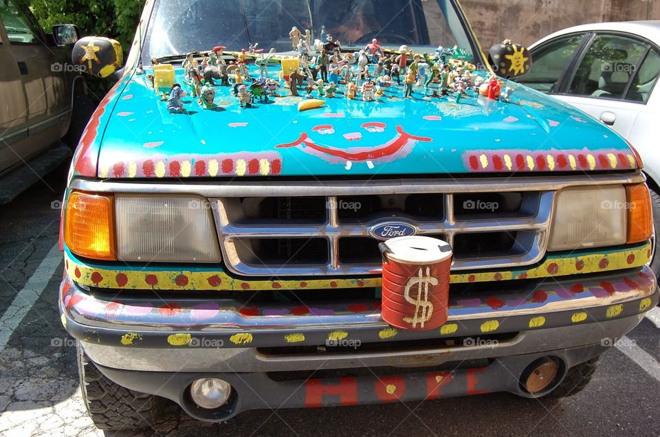 Tiny action figures glued to the hood of a FORD pick-up truck in Lewisburg, West Virginia. Donations encouraged.