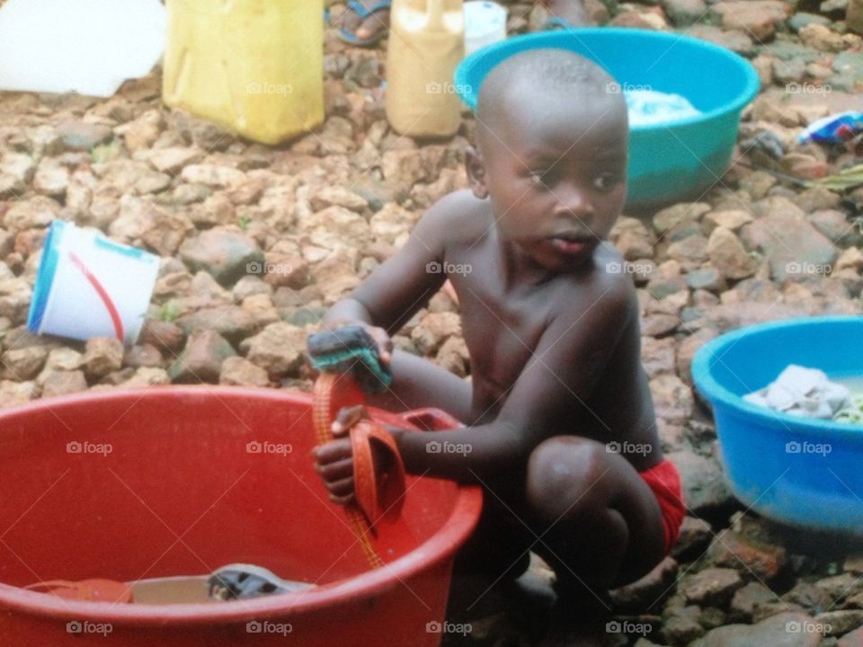 African Boy Washing Shoes