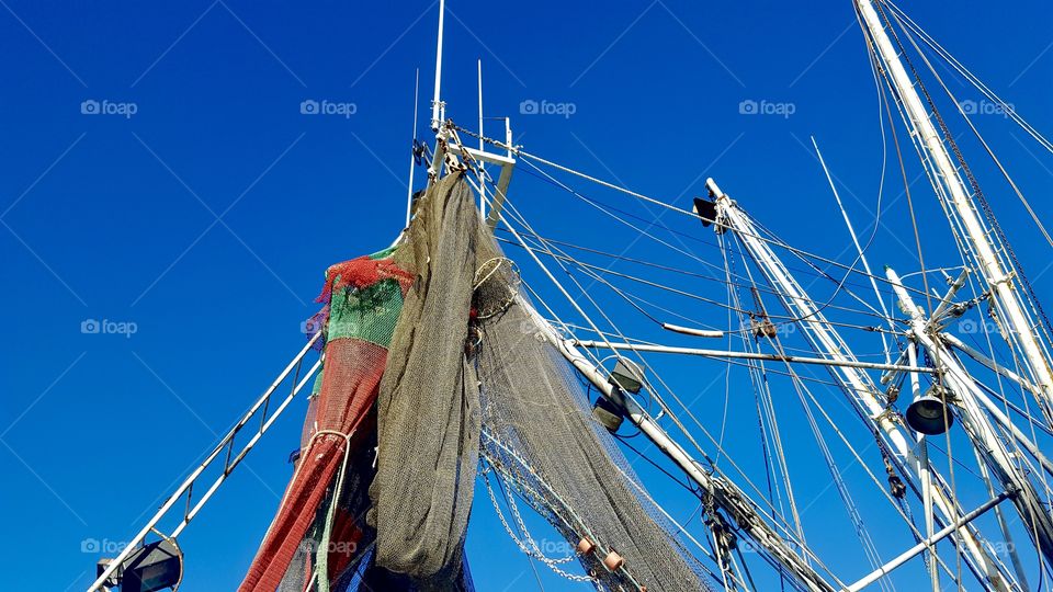 Masts, nets, and rigging on oyster boat 