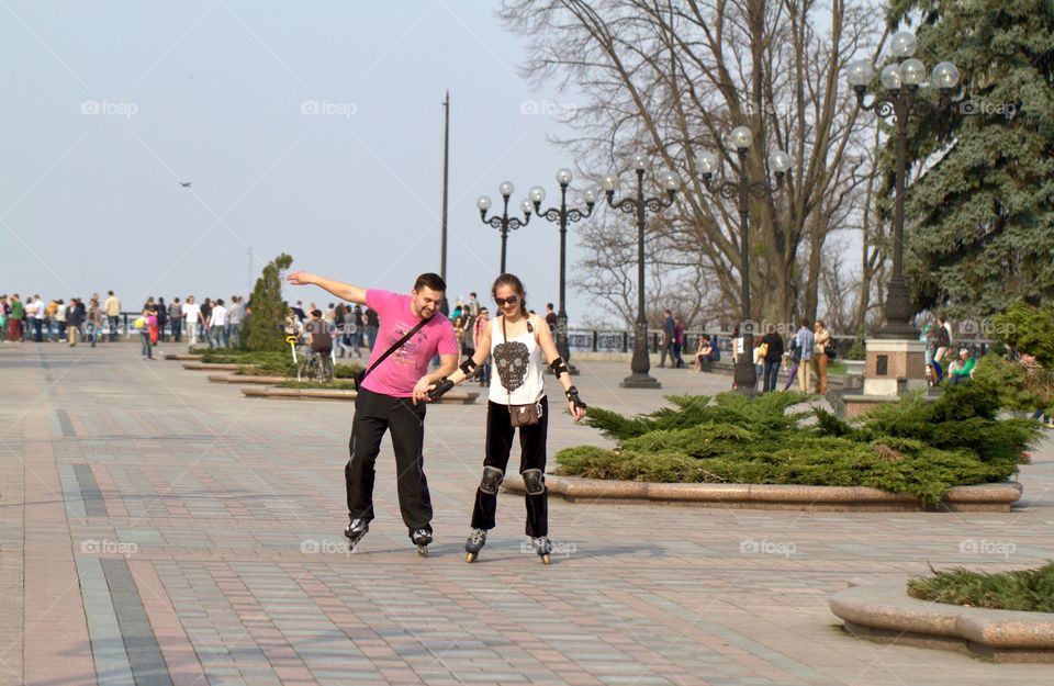 Couple skating on street