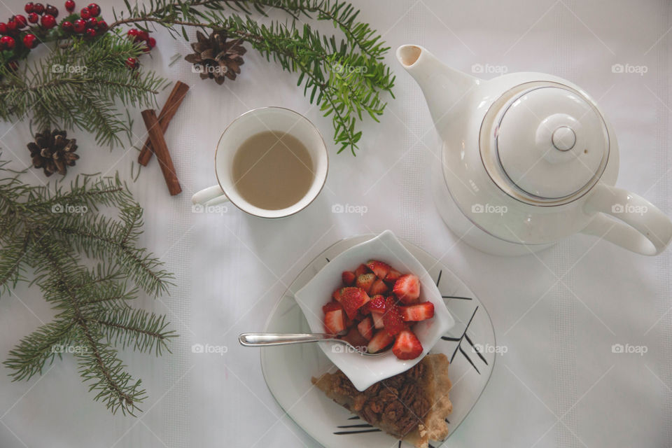 Tea, strawberries and pecan pie in a festive flat lay.