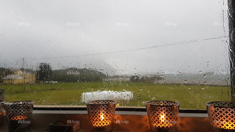 Lighted candles near a window