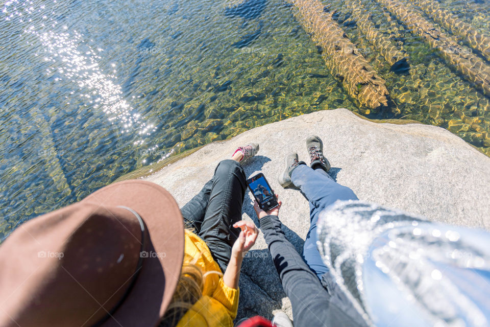 Girls sitting on a rock 