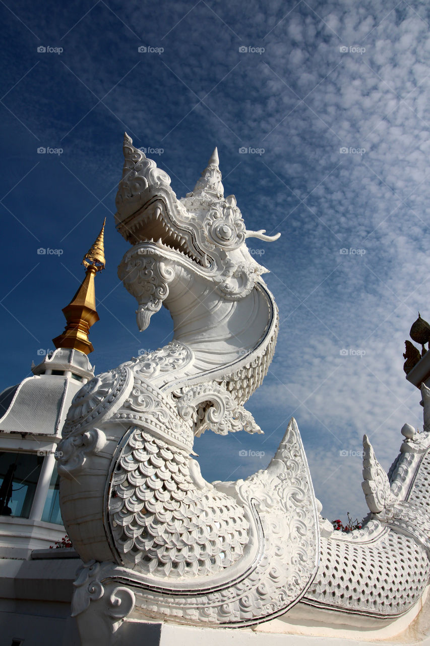 Dragon statues adorn the railing the temple