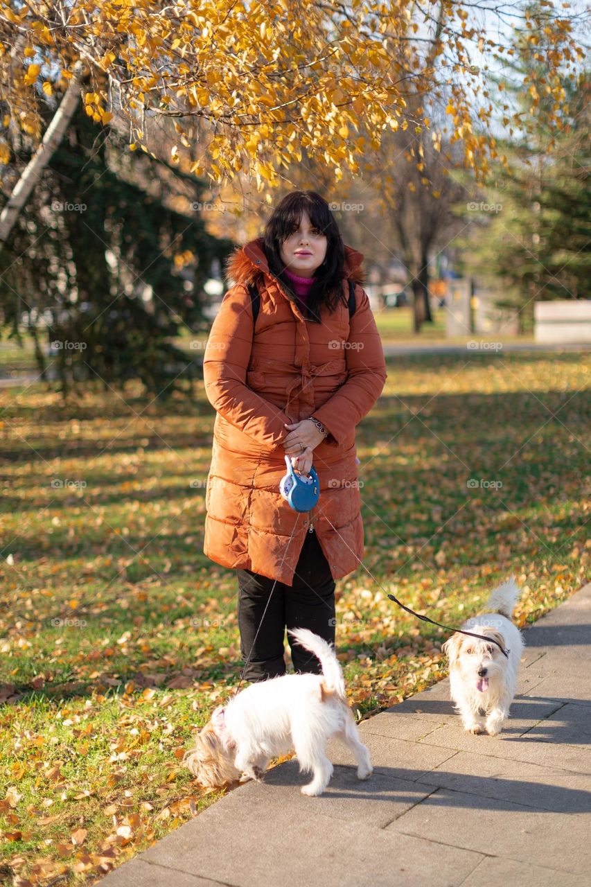Portrait of lady and puppies in autumn