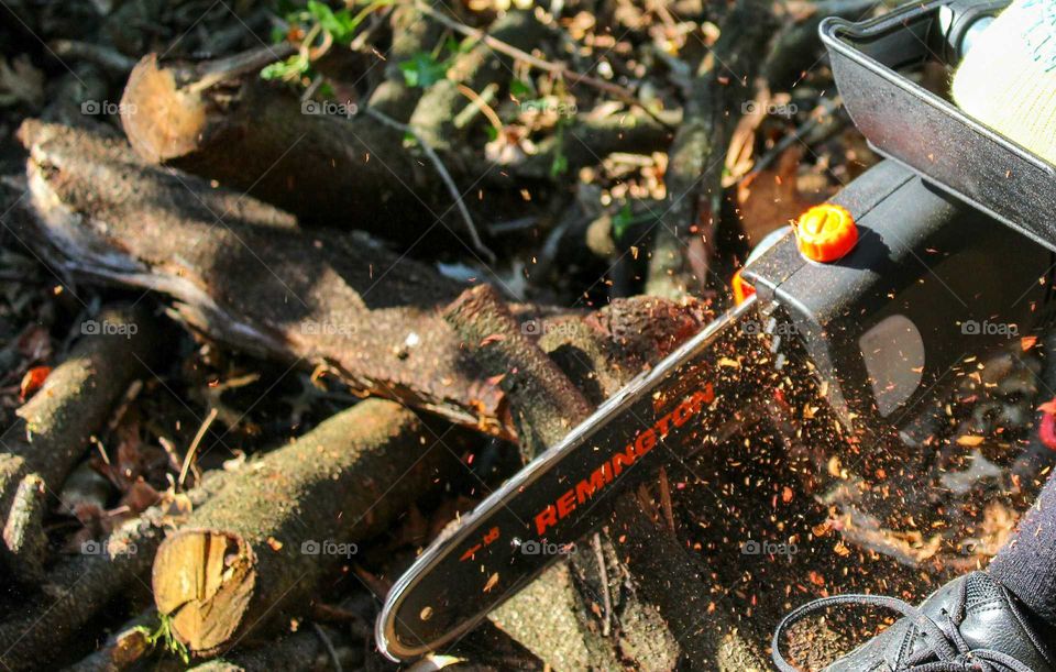 Cutting logs with a Remington electric chainsaw