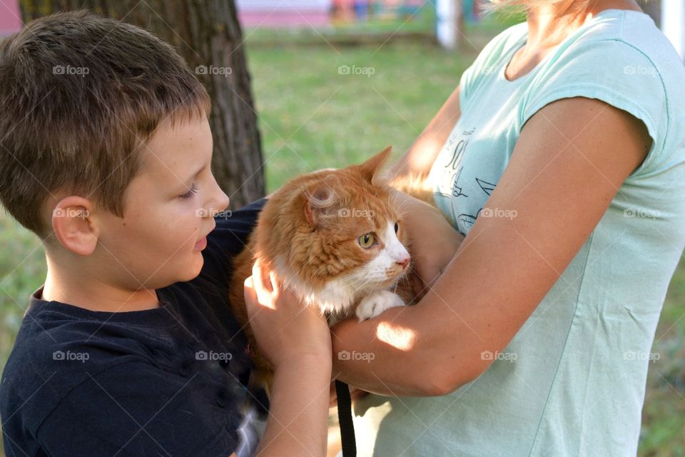 family mother and son with cat happy outdoor