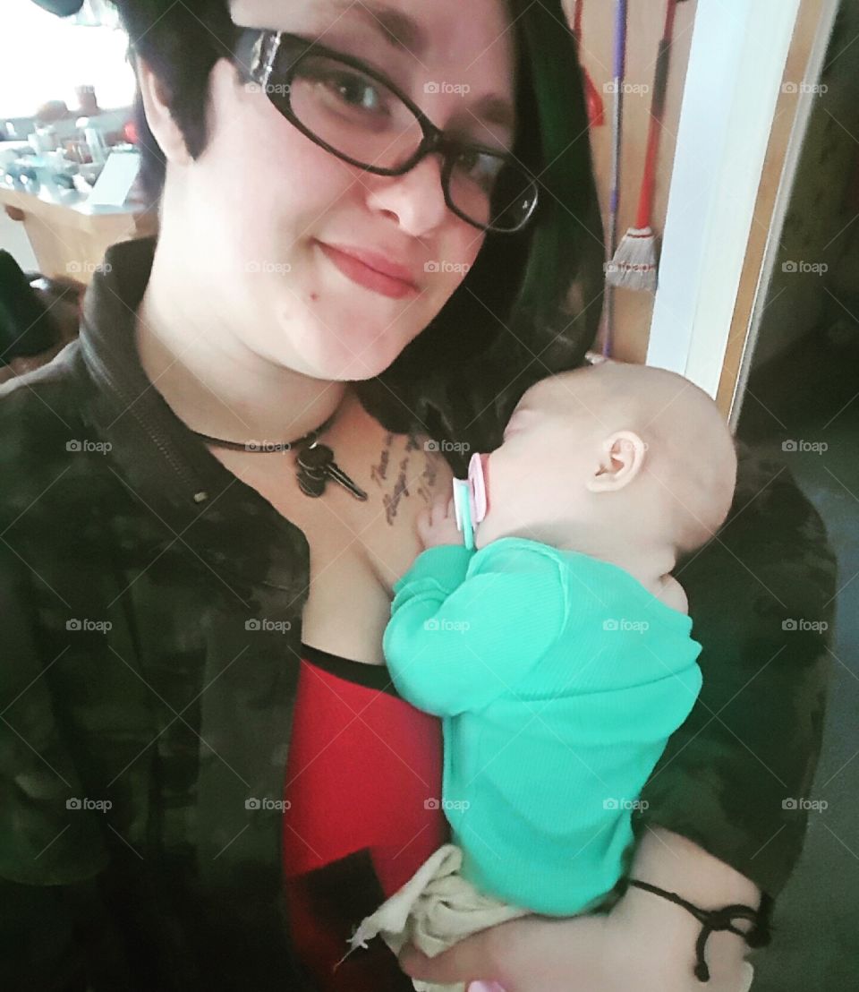 holding sleeping baby girl
