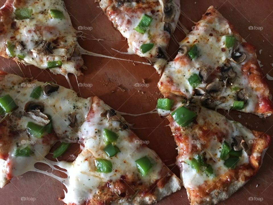 Veggie pizza with marinara sauce, cheese blend of mozzarella and fresh Parmesan, Italian seasoning, mushrooms and green peppers on a whole wheat pizza bread for crust. Absolutely amazing. 