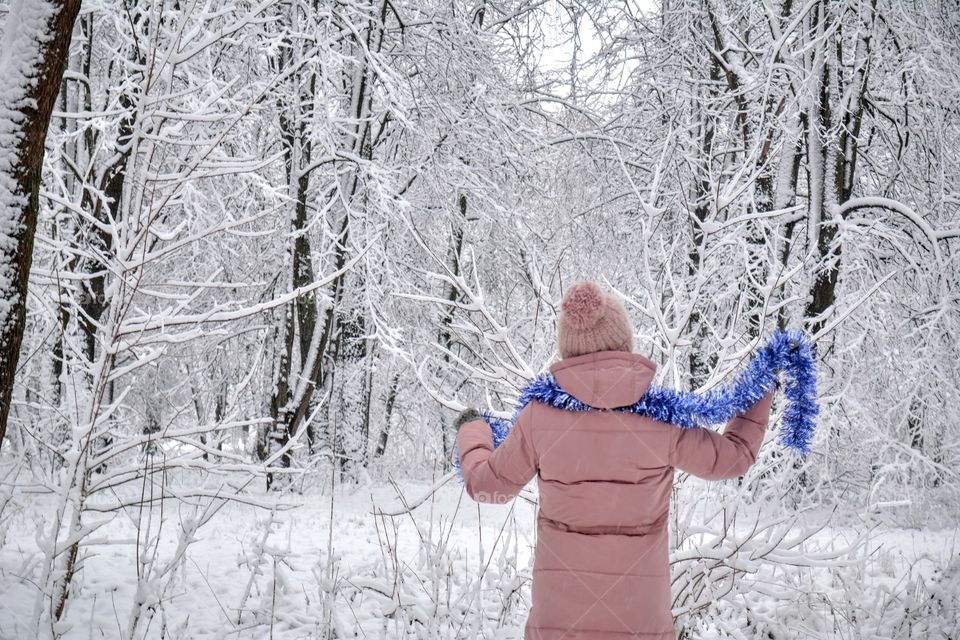 girl walking in the snowy park Christmas time