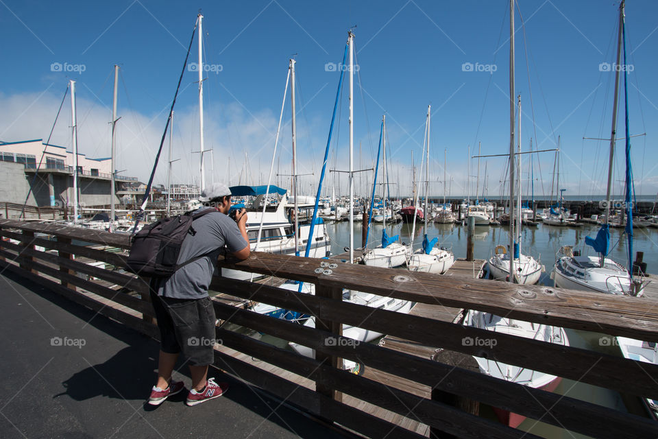 Photographer traveler at the port with yacht boat  in San Francisco CA USA