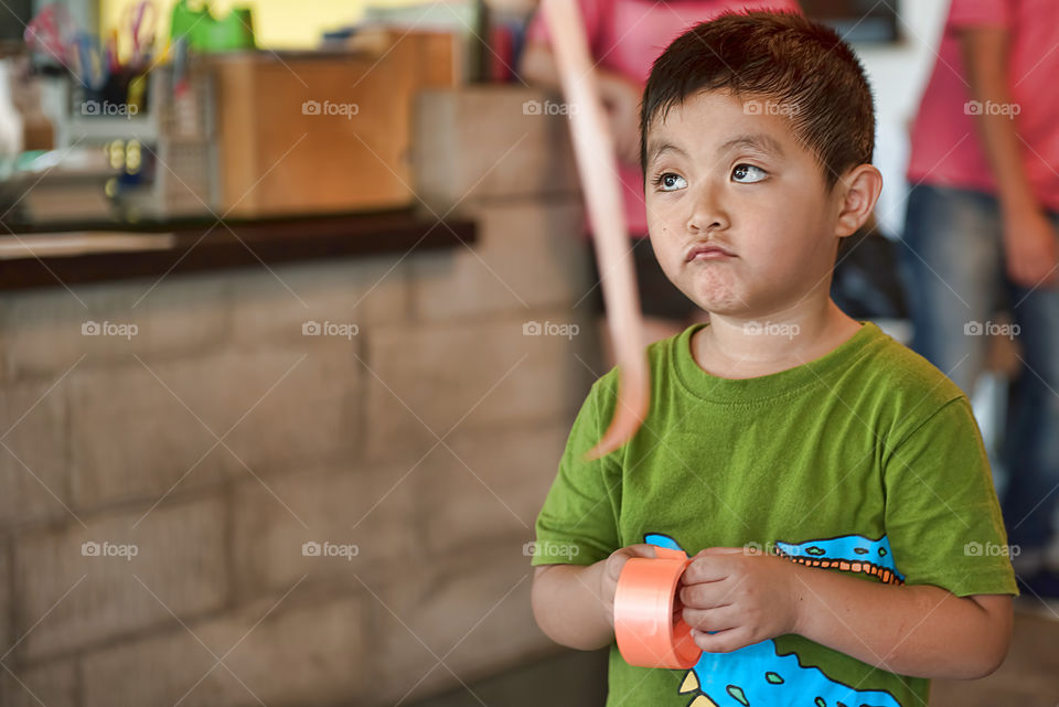 Close-up of a boy holding ribbon roll