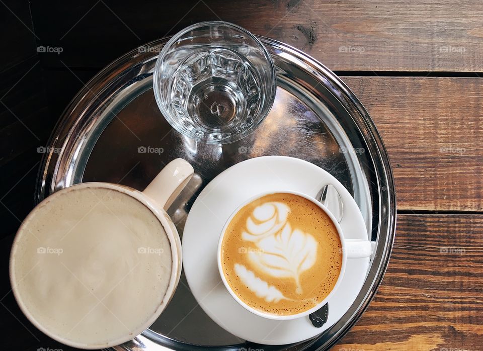 Cups of coffee on the wooden table 