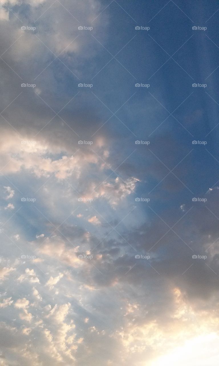 Sun Rays  Interesting Clouds
Colors are Light 
And spread around 
As if a feather brush 
Was used in this picture captured
Blue Sky View
How neat for me to see 
An interesting picture
Such as this to me .