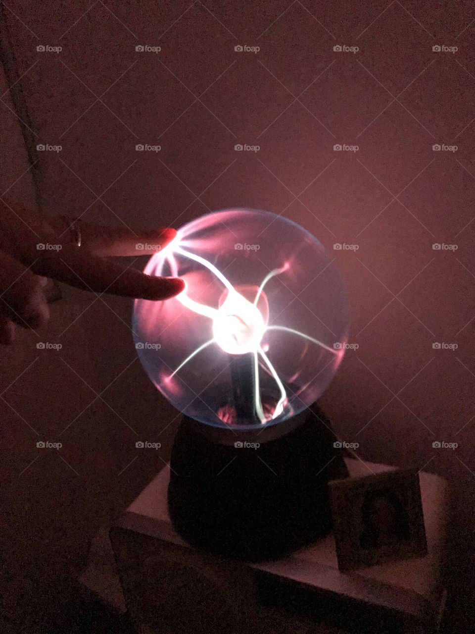 Energy gas ball touching with fingers 