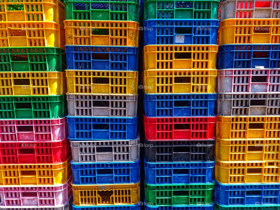 Arrangement of colorful plastic baskets for storage of various items.